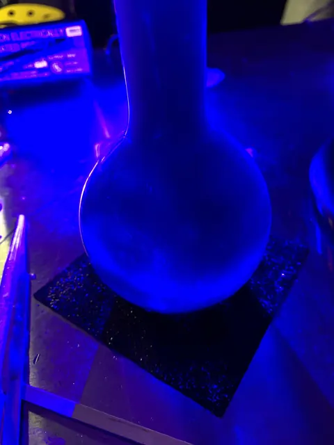A flask lit blue.