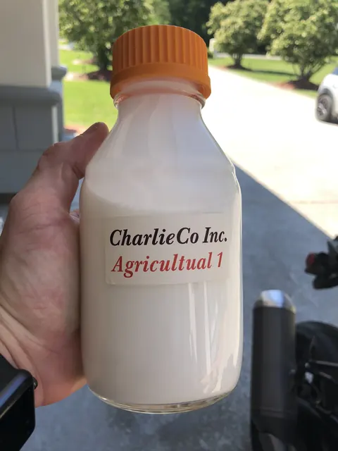 A bottle labelled by hand: CharlieCo Inc.