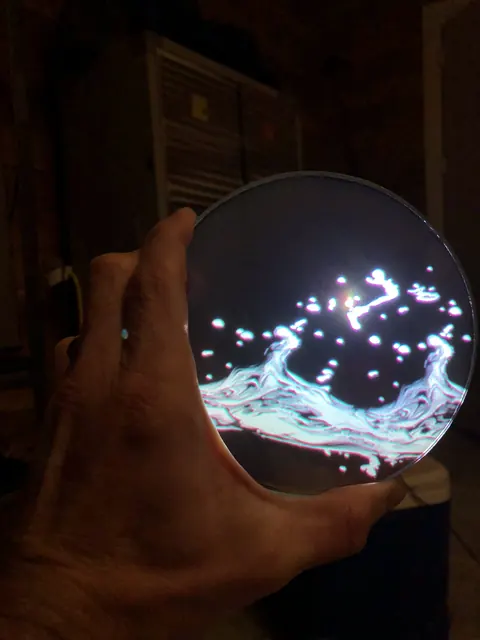 A coated disc held to the light.