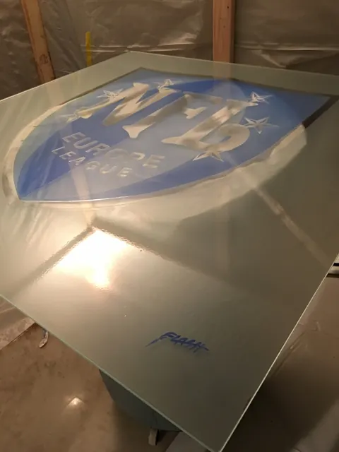 The same curved panel, unlit. The object had to earn its place before the projector came on.